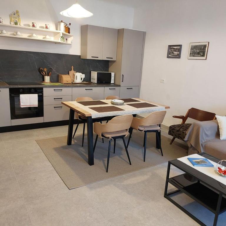 Fully equipped kitchen and dining table beside the apartment living area