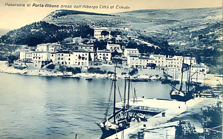 Historic panorama of Rabac, with waterfront houses below the hillside and sailing boats in the harbour